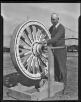 Barnes Circus worker Dan C. Parker touches up a wheel, Baldwin Park, 1936