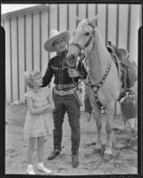 Ken Maynard shows Florence Kroiss his horse, Tarzan, Van Nuys, 1936