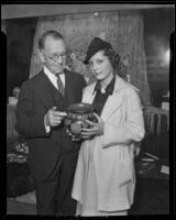 Dr. F. W. Hodge inspects with Miss Peggy Sudduth a rare specimen of early California pottery, Santa Ana, 1936