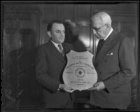 Franklin Lowney presents safety plaque to William May Garland, Los Angeles, 1936