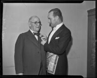 Henry Simon Baer receives a Freemason's gold service button from Truman Van Dyke, Los Angeles, 1936