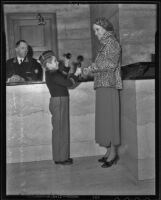 Elmer Spangler helps Verna Everitt with a telephone call at the Biltmore, Los Angeles, 1935