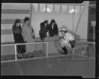Mrs. Clarence Crabbe, Estella Duffy, Mary Roberman, and Alice Keller watch Miss Elizabeth Morton prepare for the Debutante Derby, Santa Anita, 1935