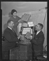 Captain A. C. Jewell, Rose Hawley and Col. R. E. Frith stack Christmas gifts, Los Angeles, 1935
