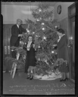 Dr. J. L. Pomeroy, Vivian Cammack and Vivien Bremer decorate the Health Department's Christmas tree, Los Angeles, 1935