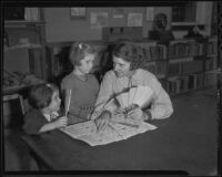 Virginia Rice Wheeler showing Sally and Joanna how to play with an antique game, Exposition Park, Los Angeles, 1935