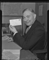 Harry H. Streshly poses with an envelope addressed to Santa Claus, Los Angeles, 1935