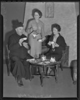Reverend G. G. Fox, Miss Margaret Halff and Mrs. Vincent Cunningham take tea, 1935