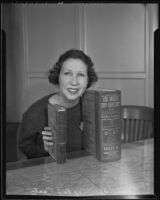 Miss Bernice McCarty compares the 1887 Los Angeles City Directory with the new and improved 1936 Los Angeles City Directory, Los Angeles, 1936