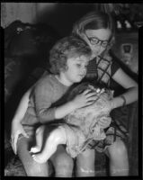 Sisters Jean and Phyllis Thomson (10 and 4) with Phyllis' broken doll, Los Angeles, 1935