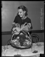 Lorraine Lyon, Volunteers Orphanage employee, dresses a fruit basket, Los Angeles, 1935