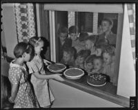 Two Volunteer of America members prepare pies to share with an orphanage on Thanksgiving, Los Angeles, 1935