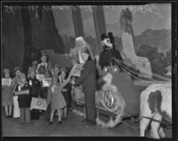 Children receive gifts at the Shriners' Christmas party, Los Angeles, 1935