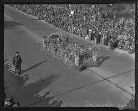 Official in a flower-covered automobile at the Tournament of Roses Parade, Pasadena, 1936