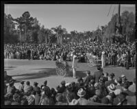 Girls in a rickshaw drawn by a boys next to the "Chinese Empress" float in the Tournament of Roses Parade, Pasadena, 1936