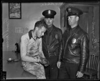 Fred Powers sits captured in handcuffs while police H. C. Bryan and M. C. Blake stand watch, Los Angeles, 1936