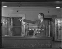 Detective Lieutenant Frank McGlinchey demonstrates how he shot and wounded bank bandit, Los Angeles, 1936