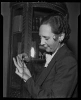 Clara B. Simons looks at a diamond bracelet, Los Angeles, 1936