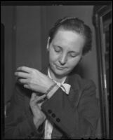 Clara B. Simons tries on a diamond bracelet, Los Angeles, 1936