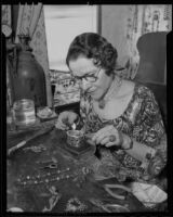 Doris Clif working with a piece of jewelry, Los Angeles, 1936