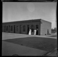 Two women approach the cribs on Alameda Street, Los Angeles, 1896