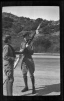 H. H. West Jr. and another boy hold a Boy Scouts flag in Griffith Park, Los Angeles, about 1932