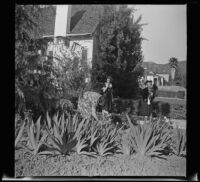 Dorothea Siemsen and Mertie West watch Elizabeth Siemsen pick flowers, Glendale, 1942