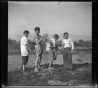 Four Boys Scouts dress after a swim in the Los Angeles River, Los Angeles, about 1933