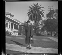 Mertie West poses with a large palm tree in the background, Los Angeles, 1941