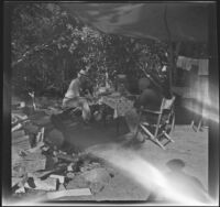 H. H. West and his brother-in-law, Forrest Whitaker, sit at a campsite, Toms Place, 1942