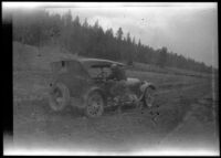 Near Bright Angel Point in Grand Canyon National Park, one of the H. H. West group gets a car out of the mud, 1923