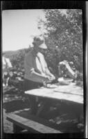 Woman prepares food at campsite at Twin Lakes, Bridgeport vicinity, 1929
