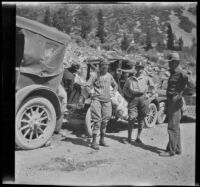 Agnes Whitaker, Mertie West, and Forrest Whitaker pose as Romayne Shaw puts water in his car and H. H. West Jr. climbs on the car, Yosemite National Park, 1929