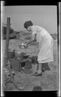Mertie West cooking on a camp stove, San Onofre, about 1925