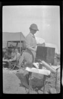 Josie Shaw cooks over the gasoline stove, San Onofre, about 1925