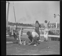 H. H. West Jr. cuts bait while Richard D. West fishes off of the San Clemente Pier, San Clemente, 1936