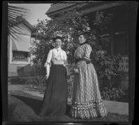 Mertie Whitaker and Nella A. West pose in front of William Shaw's house, Los Angeles, about 1900