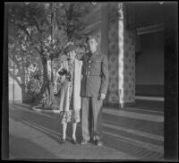 Mertie West poses with H. H. West Jr. in front of Union Station, Los Angeles, 1940