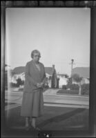 Nella West standing in a front yard, photographed by H. H. West, Jr., Los Angeles, circa 1925
