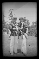 H. H. West Jr. and another boy crisscross their clarinets after a school parade, Alhambra, 1937