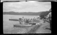 People on a boat landing and on the shore of Lake Arrowhead, circa 1923