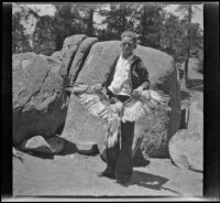 H. H. West, Jr. shows off a hawk killed by Neil Wells, Big Bear, 1932