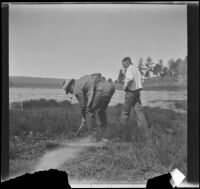 Neil Wells and H. H. West, Jr. digging for worms near the lake, Big Bear, 1932