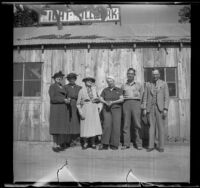 Group photograph of Minnette Worley, Maud Foreman West, Mrs. G. W. Foreman, Frances West Wells, Clarence and Wayne West standing in front of the Wells' millwork shop, Big Bear, May 7, 1940