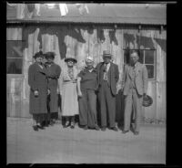Group photograph of Minnette Worley, Maud Foreman West, Mrs. G. W. Foreman, Frances West Wells, H. H. West and Wayne West standing in front of the Wells' millwork shop, Big Bear, May 7, 1940