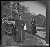 Glen and Bessie Velzy and Wilhelmina West stand by a dirt road next to the Velzy's car, Sunland-Tujunga vicinity, 1912