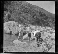 Frances Cline, Elizabeth West and Frances West wade into Big Tujunga Creek, Sunland-Tujunga vicinity, 1912
