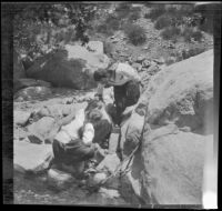 Frances West and Elizabeth West explore boulders near Big Tujunga Creek, Sunland-Tujunga vicinity, 1912