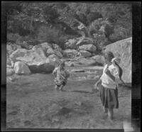 Frances Cline and Frances West wade through water in Big Tujunga Creek, Sunland-Tujunga vicinity, 1912