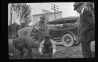 U. G. Smith helps Elmer Cole, Al Schmitz and Charlie Stavnow dig worms while H. H. West watches, Bishop, 1918